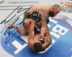 TRAVIS BROWNE SIGNED UFC MMA OCTAGON 8×10 PHOTO W/COA #3  COLLECTIBLE MEMORABILIA