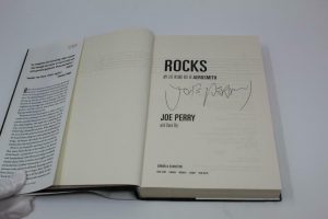JOE PERRY SIGNED AUTOGRAPH “ROCKS” BOOK – AEROSMITH GET A GRIP TOYS IN THE ATTIC  COLLECTIBLE MEMORABILIA