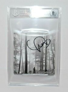 TAYLOR SWIFT SIGNED (FOLKLORE) CD COVER BECKETT ENCAPSULATED BAS 00012549390  COLLECTIBLE MEMORABILIA