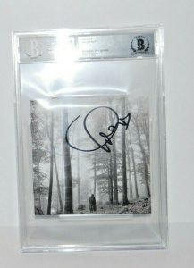 TAYLOR SWIFT SIGNED (FOLKLORE) CD COVER BECKETT ENCAPSULATED BAS 00012549383  COLLECTIBLE MEMORABILIA