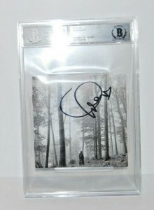 TAYLOR SWIFT SIGNED (FOLKLORE) CD COVER BECKETT ENCAPSULATED BAS 00012549379  COLLECTIBLE MEMORABILIA