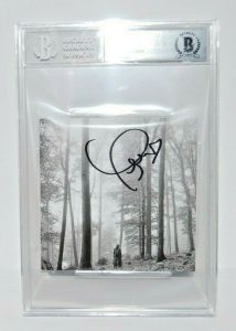 TAYLOR SWIFT SIGNED (FOLKLORE) CD COVER BECKETT ENCAPSULATED BAS 00012549389  COLLECTIBLE MEMORABILIA