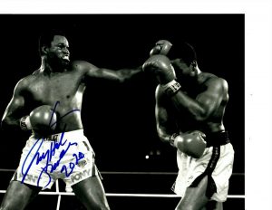 BOXING CHAMPION LARRY HOLMES SIGNED THE EASTON ASSASSIN 8X10  COLLECTIBLE MEMORABILIA
