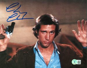 CHEVY CHASE FLETCH AUTHENTIC SIGNED 8×10 GUN IN HAND PHOTO BAS WITNESSED COLLECTIBLE MEMORABILIA