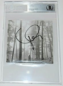 TAYLOR SWIFT SIGNED (FOLKLORE) CD COVER BECKETT ENCAPSULATED BAS 00012895071 COLLECTIBLE MEMORABILIA
