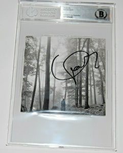 TAYLOR SWIFT SIGNED (FOLKLORE) CD COVER BECKETT ENCAPSULATED BAS 00012895083 COLLECTIBLE MEMORABILIA