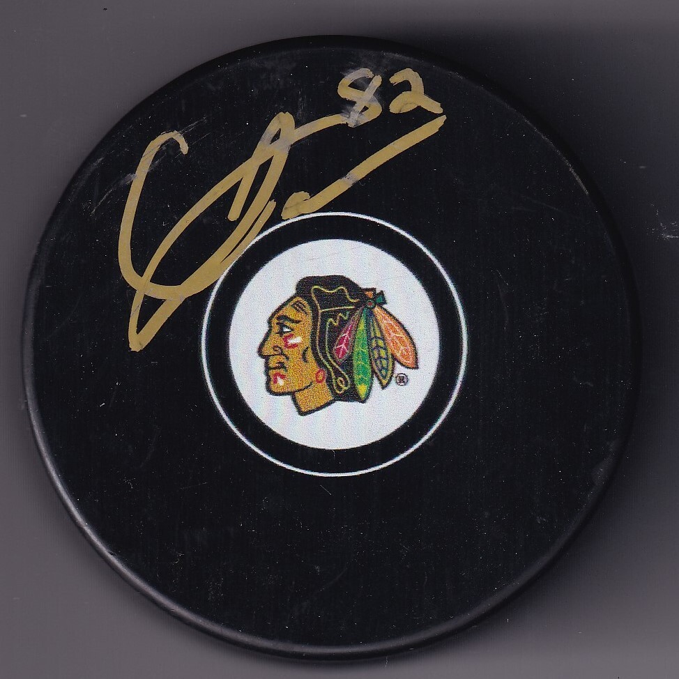 CALEB JONES signed (CHICAGO BLACKHAWKS) autograph Hockey Souvenir puck W/COA #82