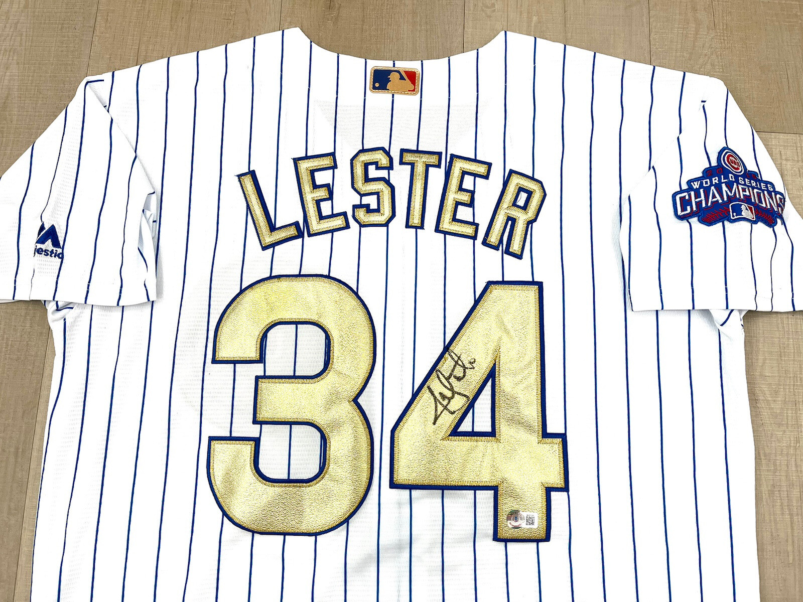 JON LESTER HAND SIGNED CHICAGO CUBS 2016 CHAMP GOLD JERSEY BAS BECKETT CERT