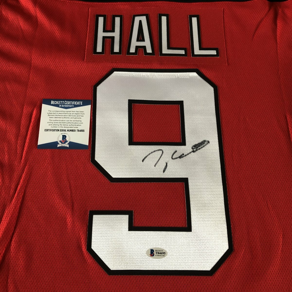 TAYLOR HALL SIGNED NEW JERSEY DEVILS #9 JERSEY w/EXACT PROOF & BECKETT BAS COA
