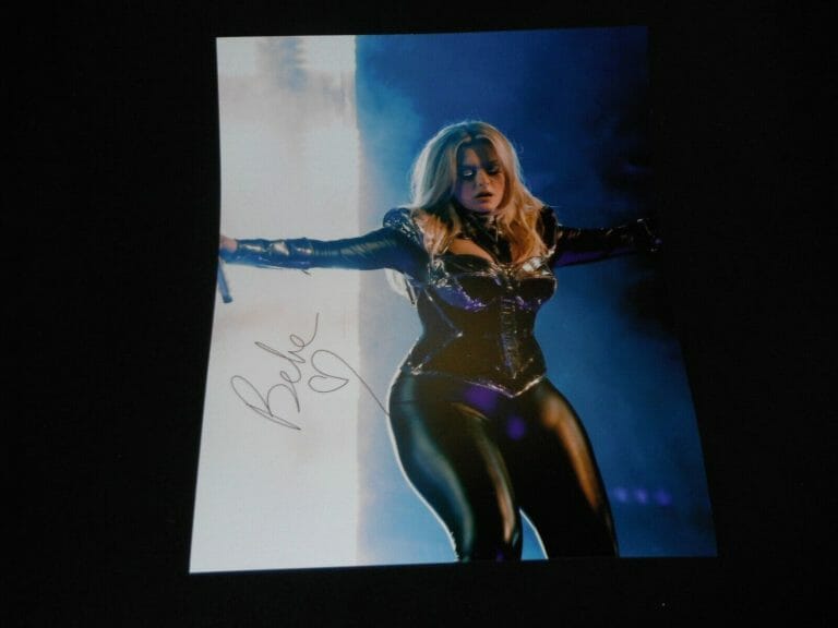BEBE REXHA SIGNED PERFORMING ON STAGE BLACK LEATHER 16X20
 COLLECTIBLE MEMORABILIA