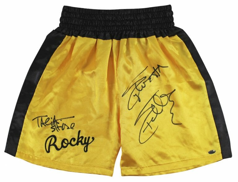 SYLVESTER STALLONE & TALIA SHIRE SIGNED YELLOW ROCKY BOXING TRUNKS BAS #AB14661
 COLLECTIBLE MEMORABILIA