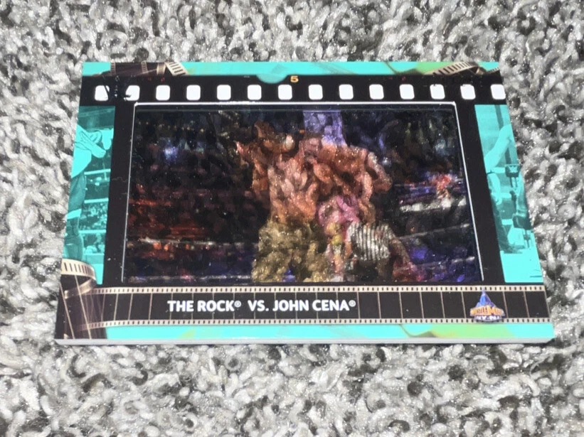 2021 Topps WWE The Rock VS John Cena Match Film Strip Relic Aqua Parallel #/299
