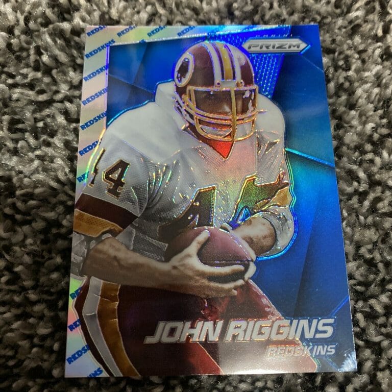 2014 PRIZM PRIZMS TEAM LOGO #153 JOHN RIGGINS /50
 COLLECTIBLE MEMORABILIA