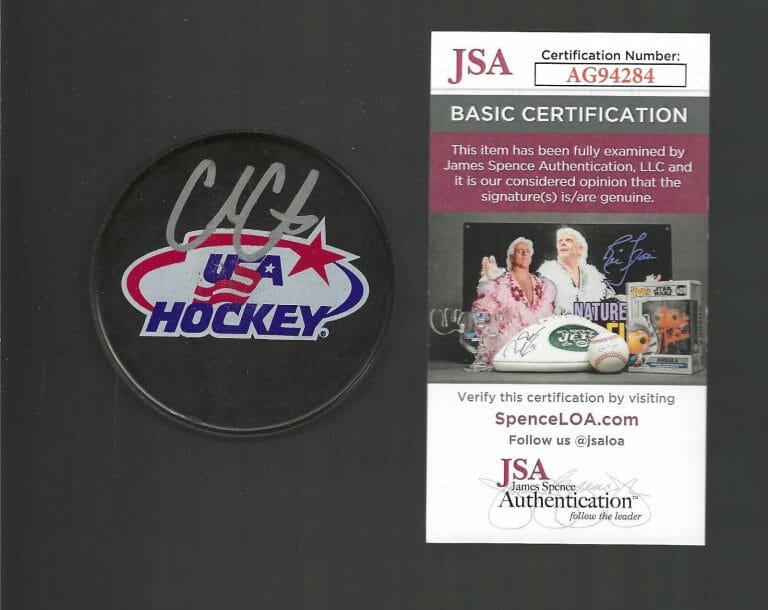 COLE CAUFIELD SIGNED USA HOCKEY SOUVENIR PUCK JSA COA MONTREAL CANADIENS
 COLLECTIBLE MEMORABILIA