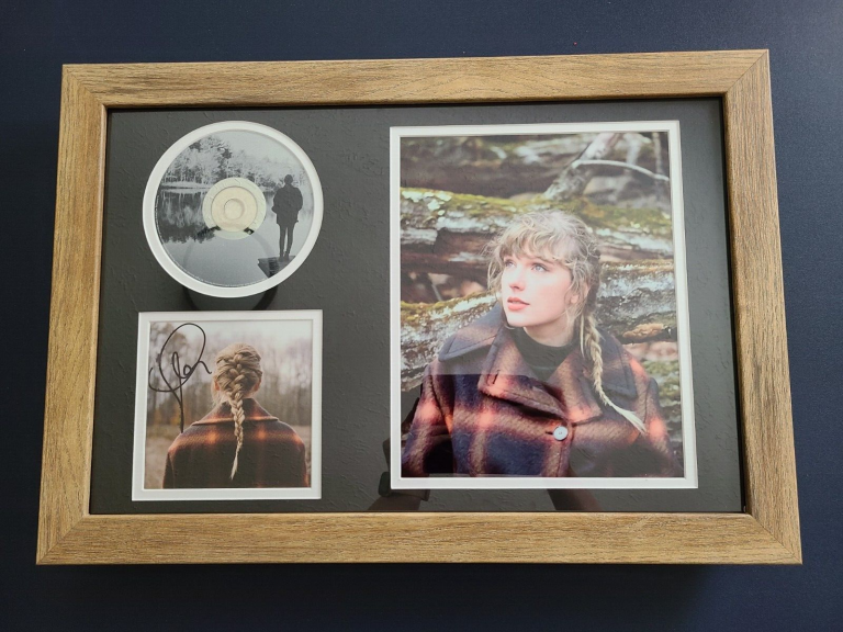 TAYLOR SWIFT SIGNED AUTOGRAPHED EVERMORE CD INSERT MATTED AND FRAMED
 COLLECTIBLE MEMORABILIA
