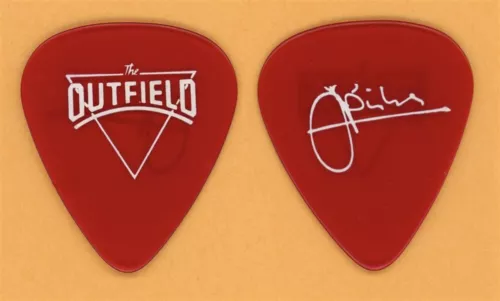 THE OUTFIELD JOHN SPINKS 1ST CUSTOM RED GUITAR PICK – 1985 PLAY DEEP TOUR COLLECTIBLE MEMORABILIA