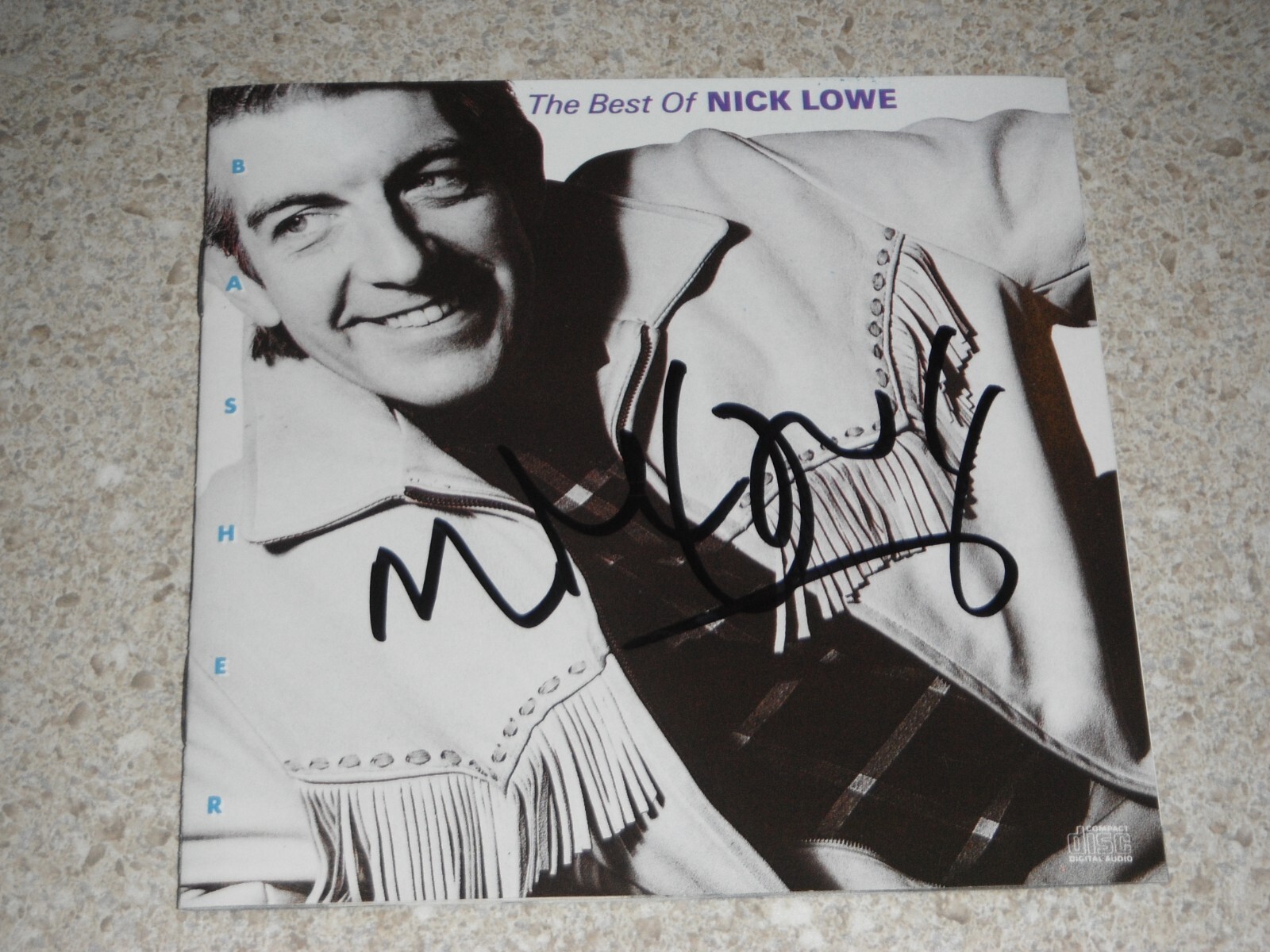 NICK LOWE SIGNED CD COVER THE BEST OF NICK LOWE