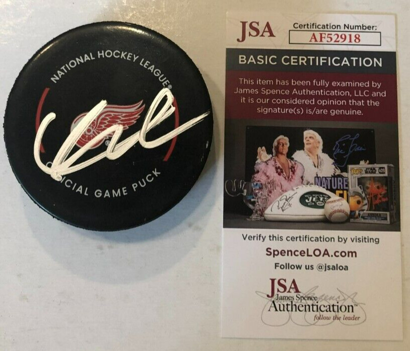 LUCAS RAYMOND SIGNED DETROIT RED WINGS OFFICIAL GAME HOCKEY PUCK W/ CASE JSA COA
