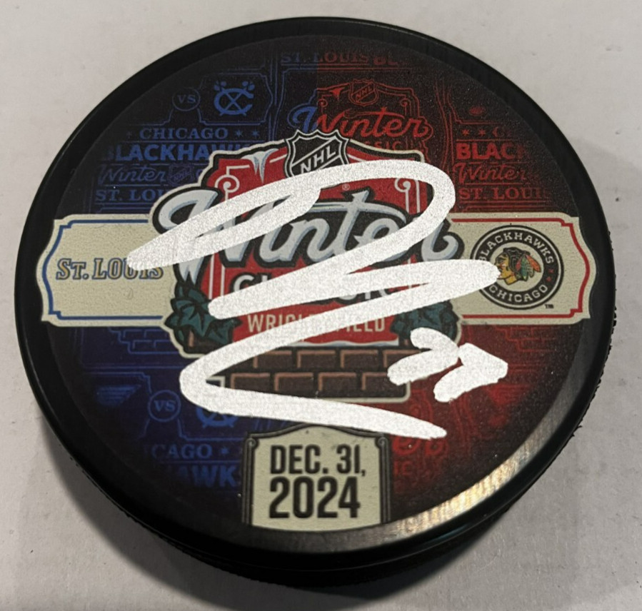 LUKAS REICHEL SIGNED CHICAGO BLACKHAWKS 2024 WINTER CLASSIC PUCK W/ CASE COA
