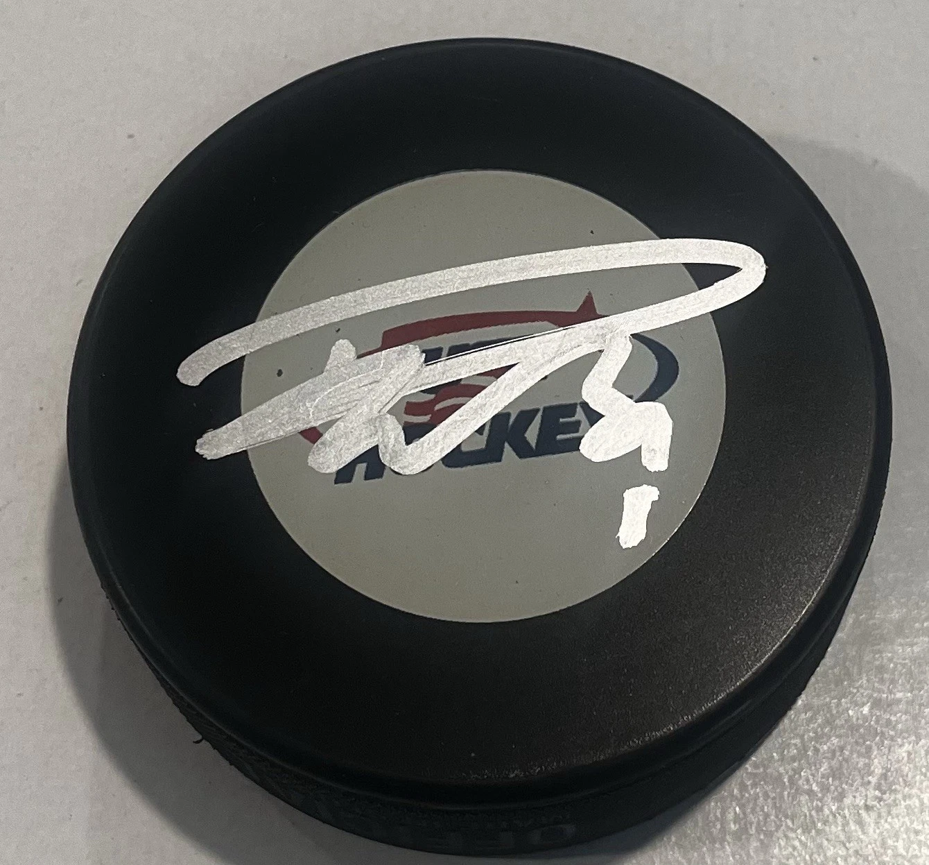 DUSTIN WOLF SIGNED USA HOCKEY PUCK W/ CASE CALGARY FLAMES COA