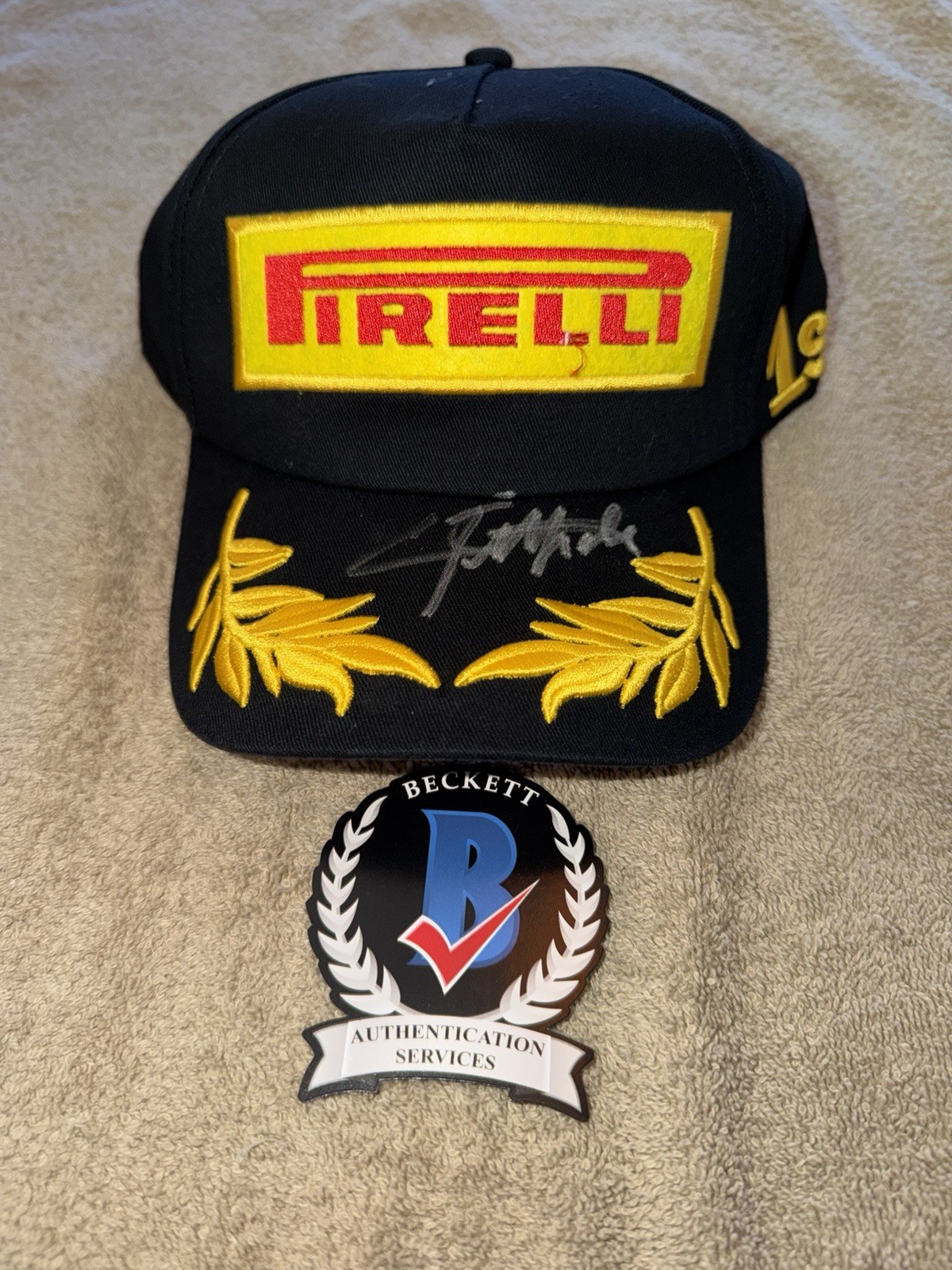 Emerson Fittipaldi Signed Pirelli Podium Hat F1 Star McLaren F1 Champion Beckett
